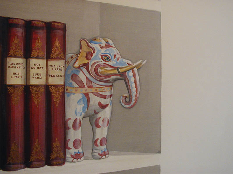 [Trompe elephant bookend on a shelf]